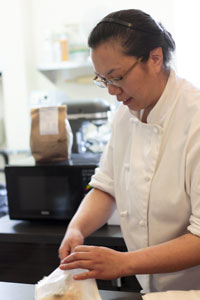 Alex Chan serves a customer at ITZA Bakeshop 