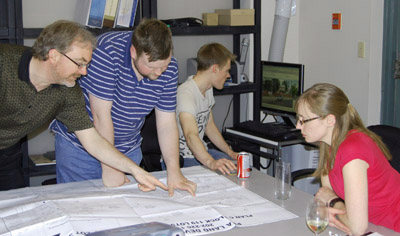 BPG members David Jacques, Jason Reid and Erin Broda review a development circulation with planning + information specialist Ben Tatterton.